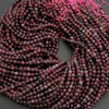 String of purple beads on a dark background