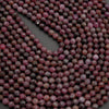 Close-up of pink and brown beads on a dark background