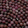 Close-up of faceted purple beads on a dark background