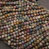 Close-up of multicolored square beads on a dark background