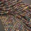 Close-up of multicolored square beads on a gray background