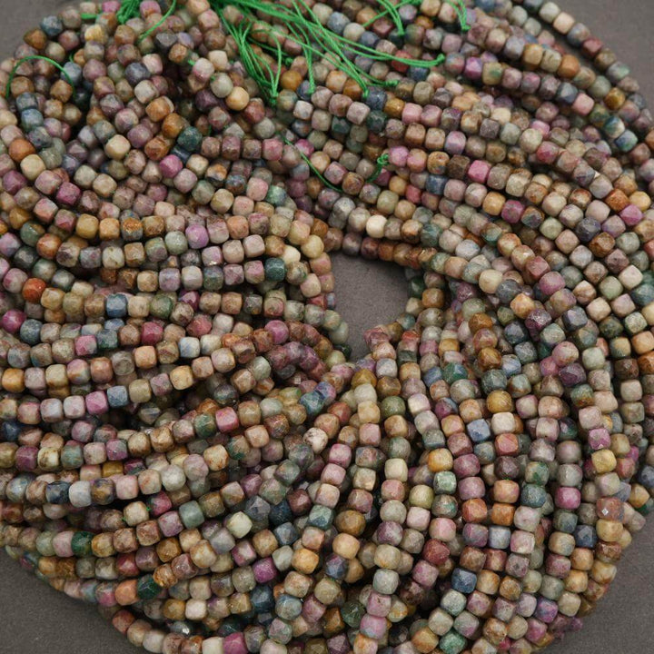 Multicolored square beads on a string against a neutral background