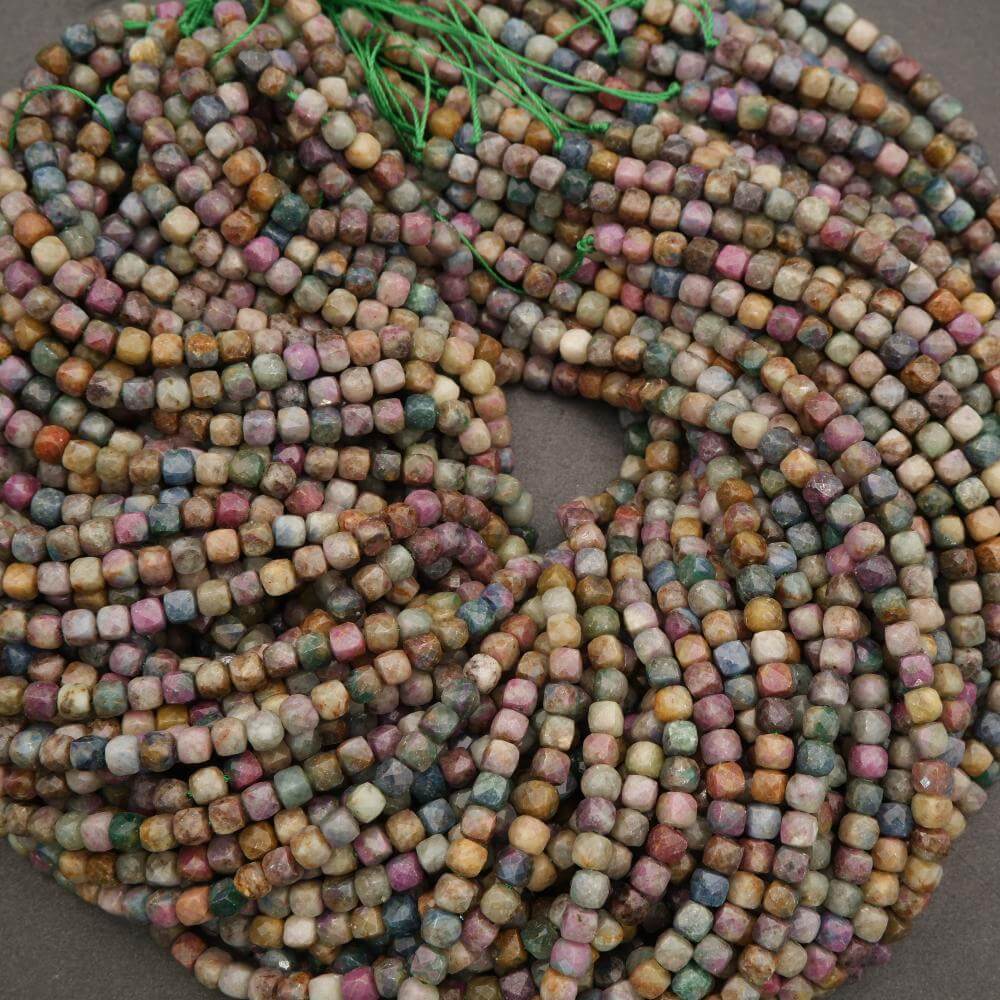 Multicolored square beads on a string against a neutral background
