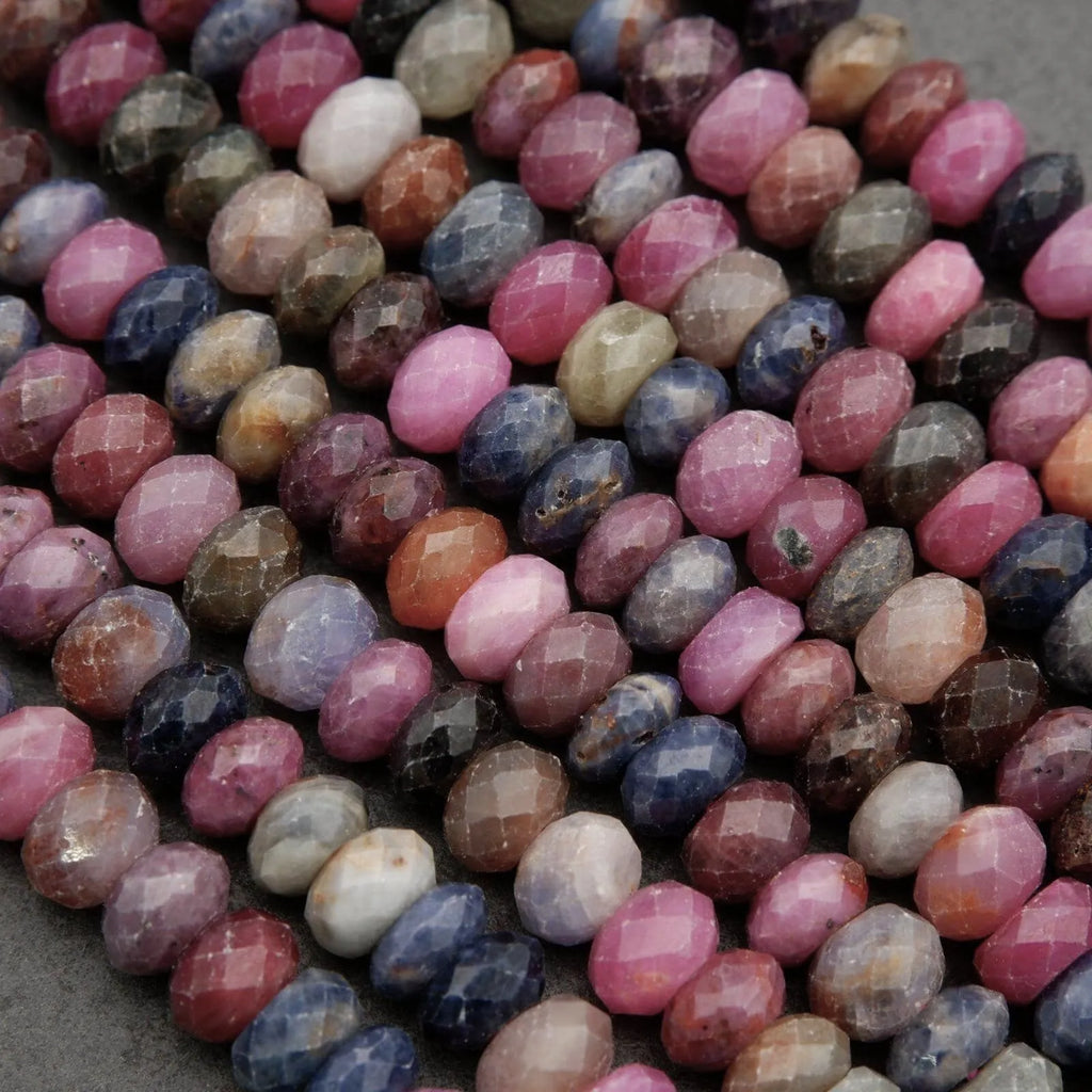 Natural ruby and sapphire gemstone beads in mixed shades of pink, blue, and earthy tones