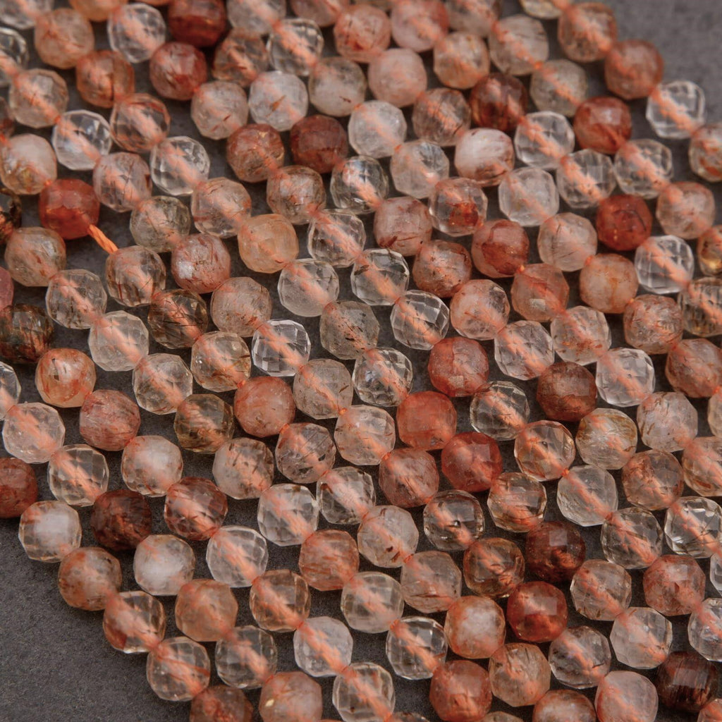 Clear faceted beads with brown needles.
