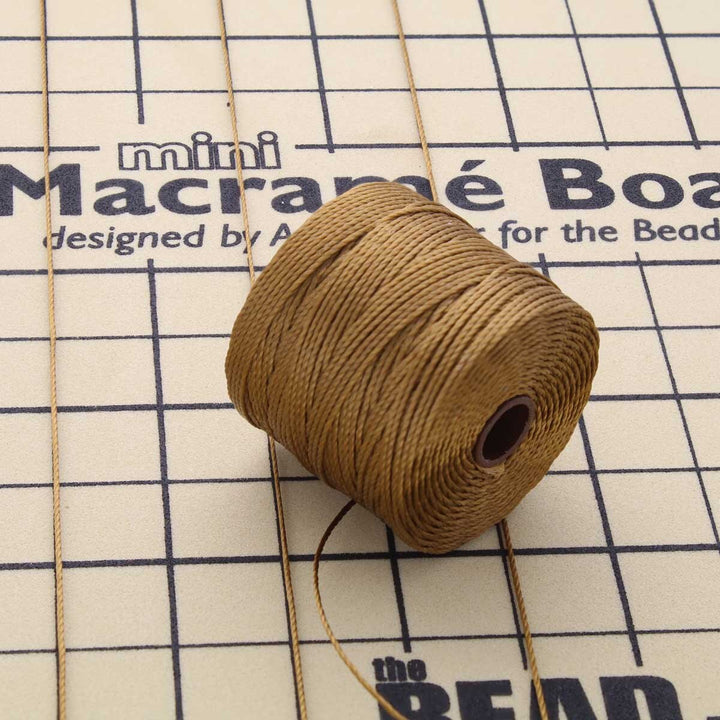 The Beadsmith S-Lon Bead Cord in antique gold, Tex 210, 77 yard spool