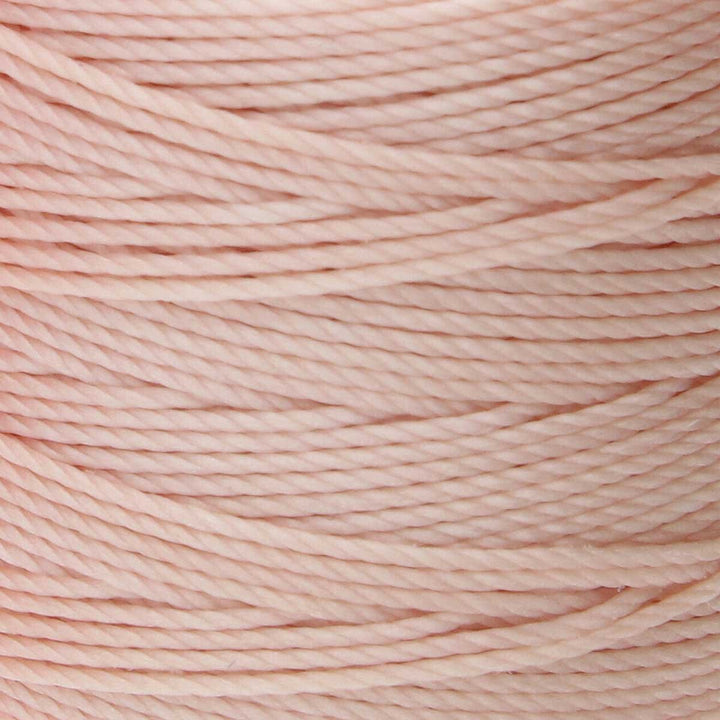 Close-up of natural 3-ply bonded nylon S-Lon Bead Cord on spool