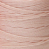 Close-up of natural 3-ply bonded nylon S-Lon Bead Cord on spool