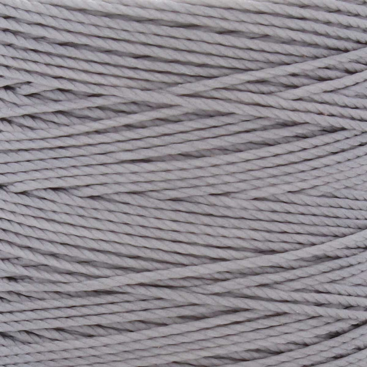 Close-up of silver 3-ply bonded nylon S-Lon Bead Cord on spool
