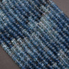 Close-up of blue beads on a dark background