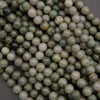 Close-up of green and white marbled beads on a dark background