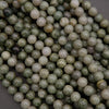 Close-up of green and white marbled beads on a dark background