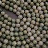 Close-up of green and white beads on a dark background