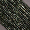 Close-up of green faceted beads on a gray background