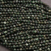 Close-up of green faceted beads on a gray background