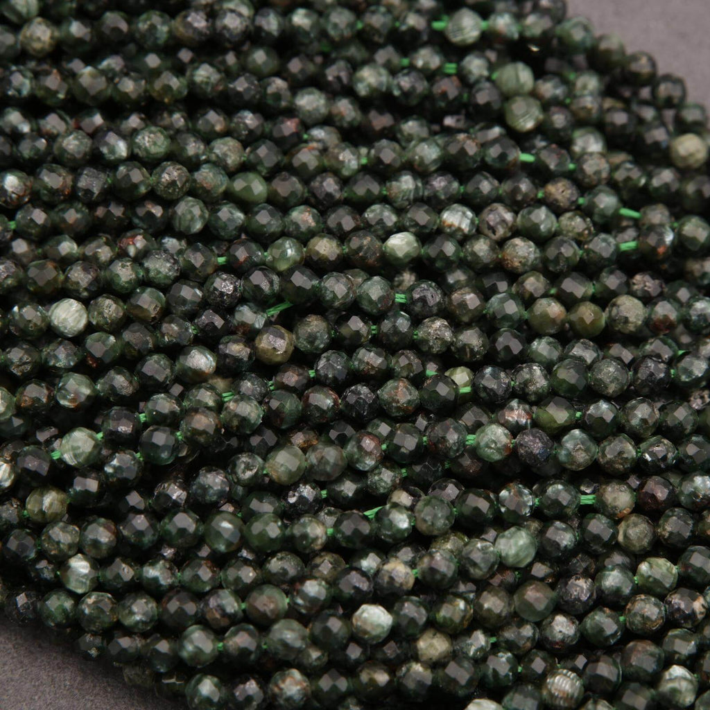 Close-up of green faceted beads on a gray background