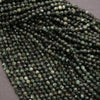 Close-up of a string of green faceted beads on a gray background
