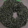 Green beaded scrunchie on a gray background