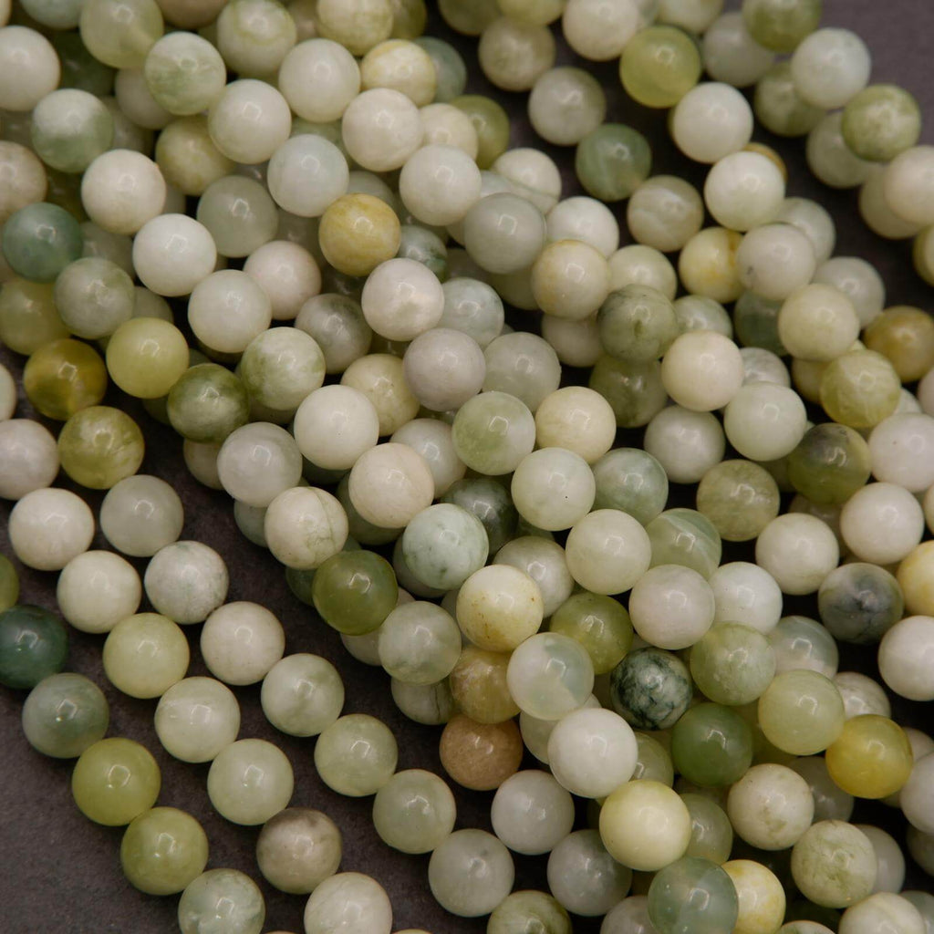 Close-up of green and white beads on a dark background