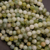 Close-up of green and white beads on a dark background