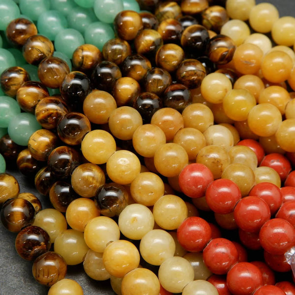 Close-up of multicolored round beads including green, brown, yellow, and red.
