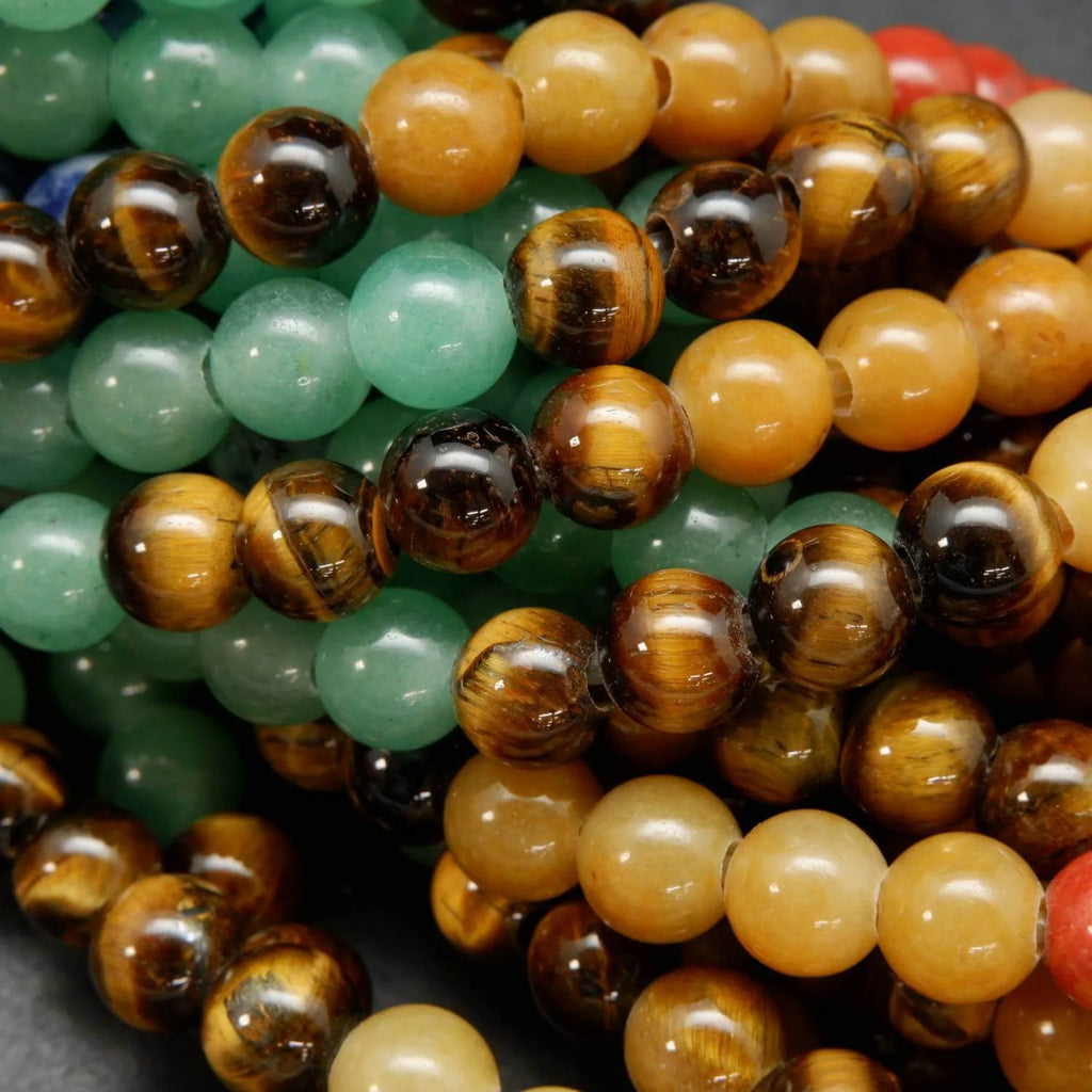 Close-up of multicolored beads including green, brown, and orange.