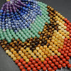 Colorful beaded strands arranged in a circular pattern on a dark surface