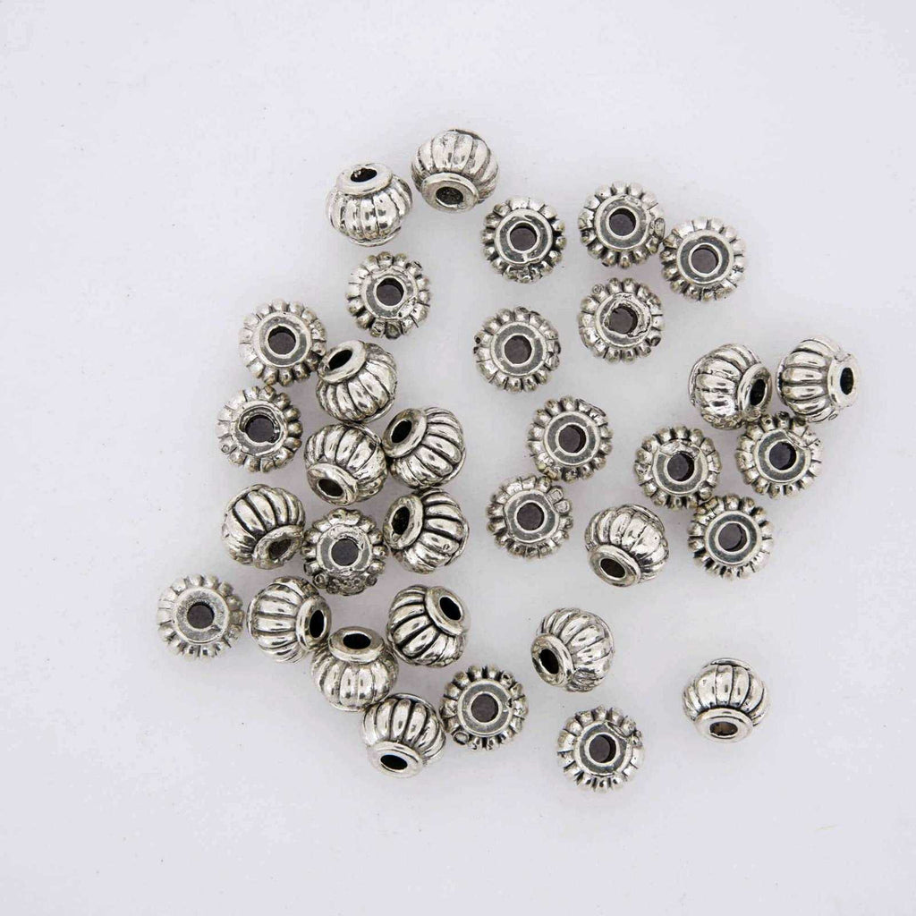 Silver jewelry finding spacer beads.