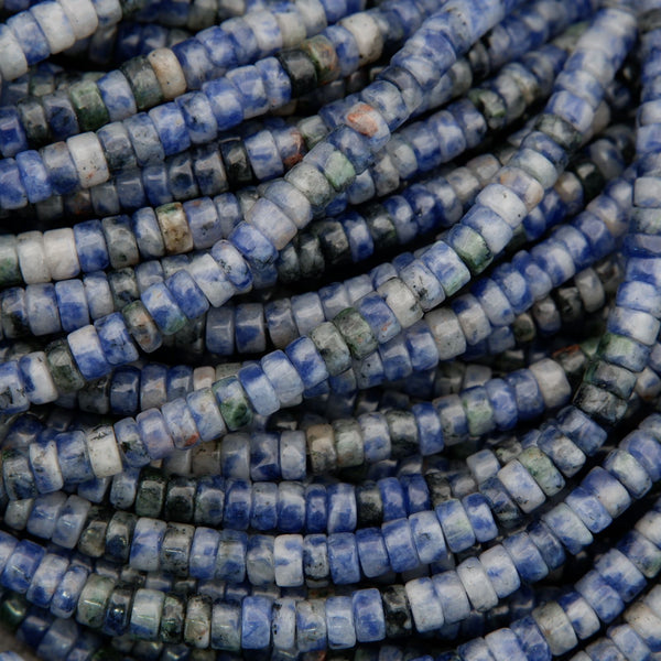 Macro image of sodalite disc beads highlighting natural stone texture and color zoning.