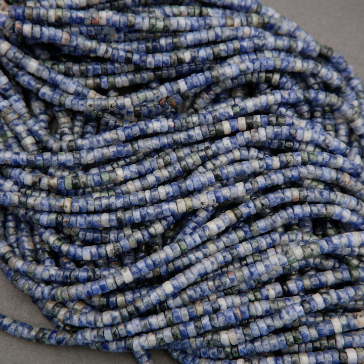 Natural sodalite heishi beads featuring cool blue hues and organic mineral inclusions.
