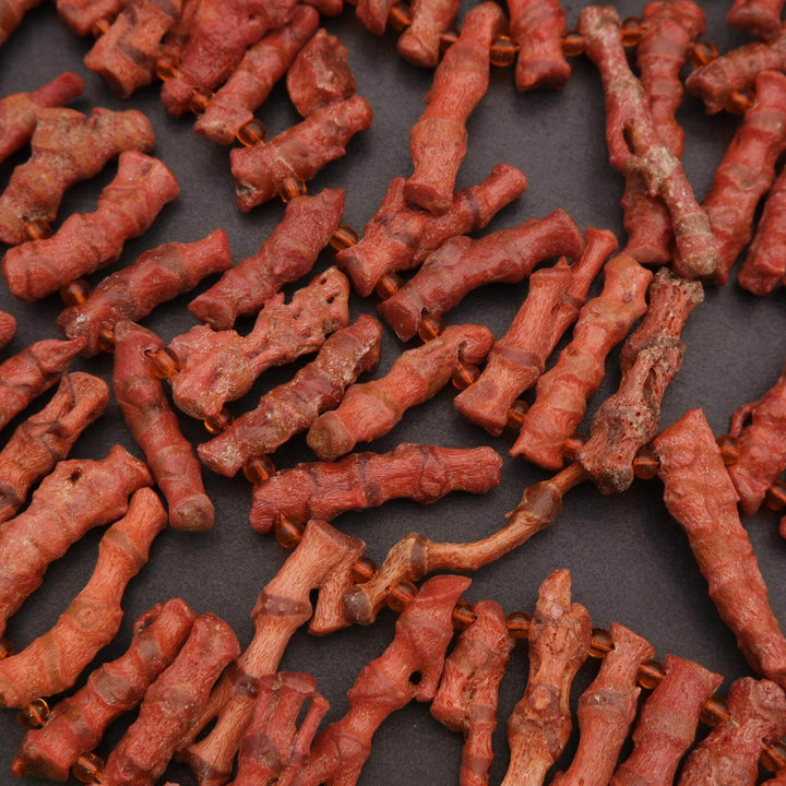 Close-up of red dog bones on a dark surface