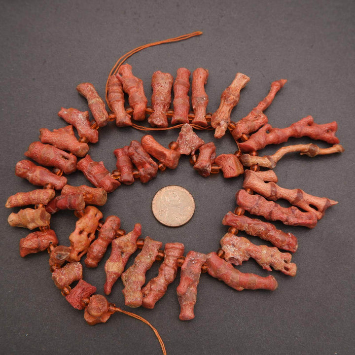 Decorative wreath made of red dried flowers on a dark background