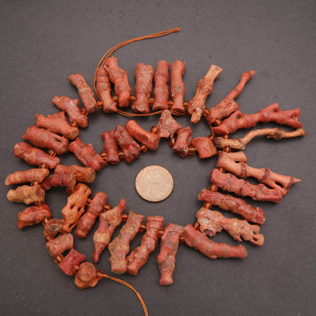 Decorative wreath made of red dried flowers on a dark background