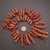 Necklace made of brown bone-like beads on a dark gray background
