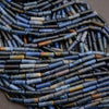 Close-up of a woven basket with blue and brown cylindrical beads.