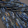 Close-up of blue and brown cylindrical beads on a gray background