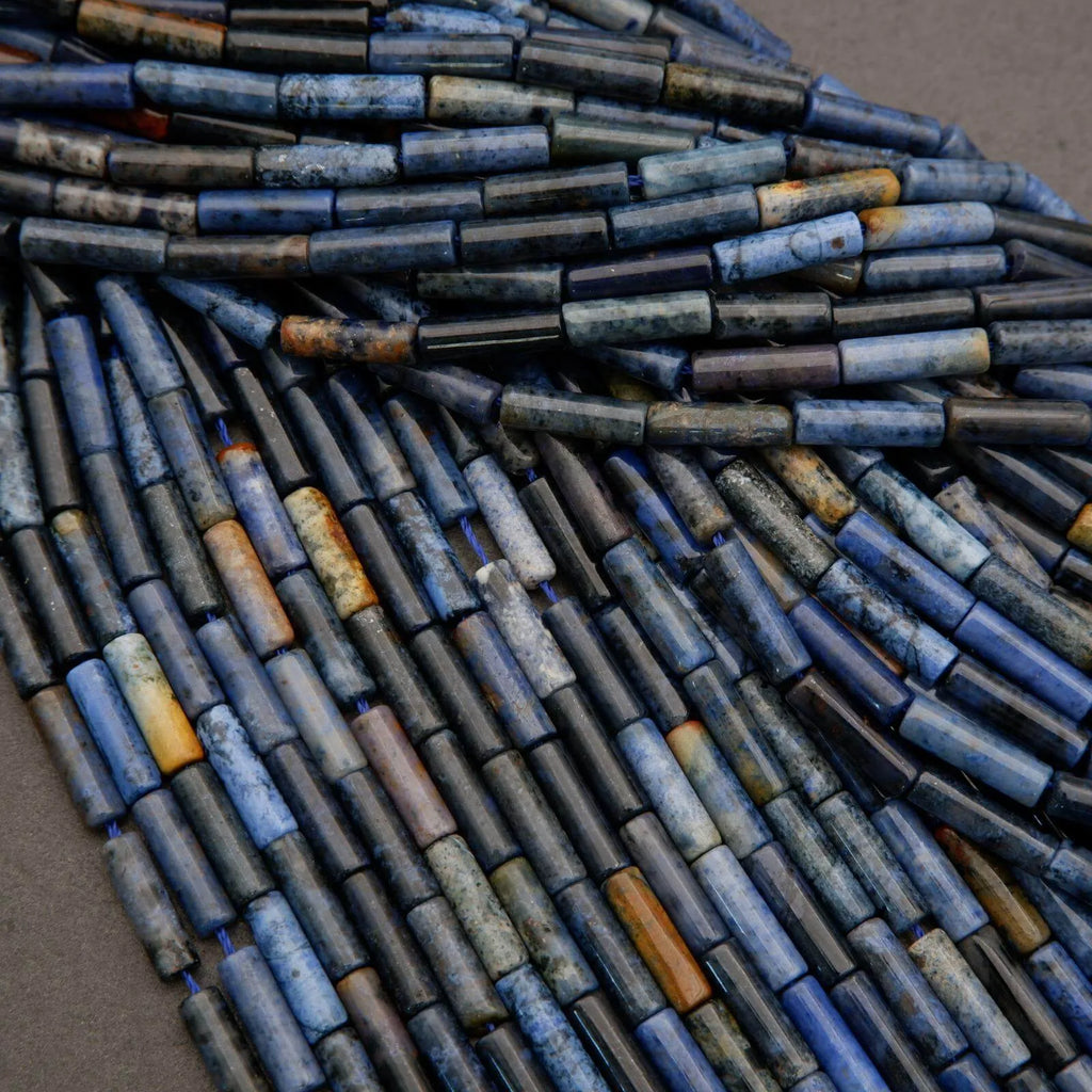 Close-up of blue and brown cylindrical beads on a gray background
