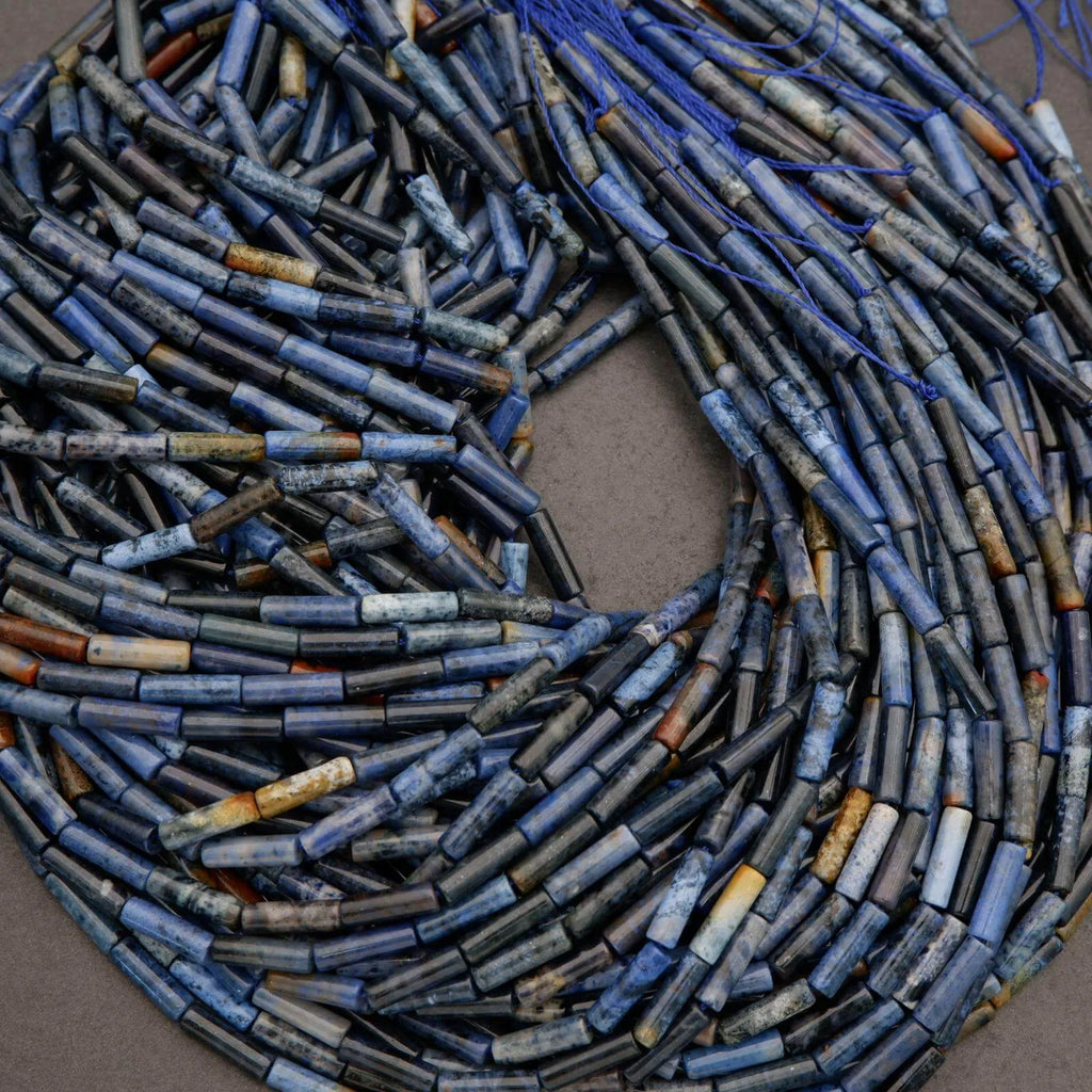 Close-up of blue and brown cylindrical beads on a gray background