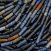 Close-up of a pile of cylindrical metal objects with various colors.