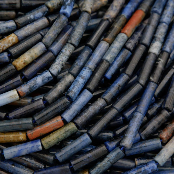 Close-up of a pile of cylindrical metal objects with various colors.