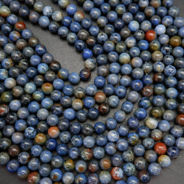Mixed blue and red sunset dumortierite beads.