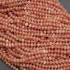Close-up of pinkish-beige spherical beads on a gray background