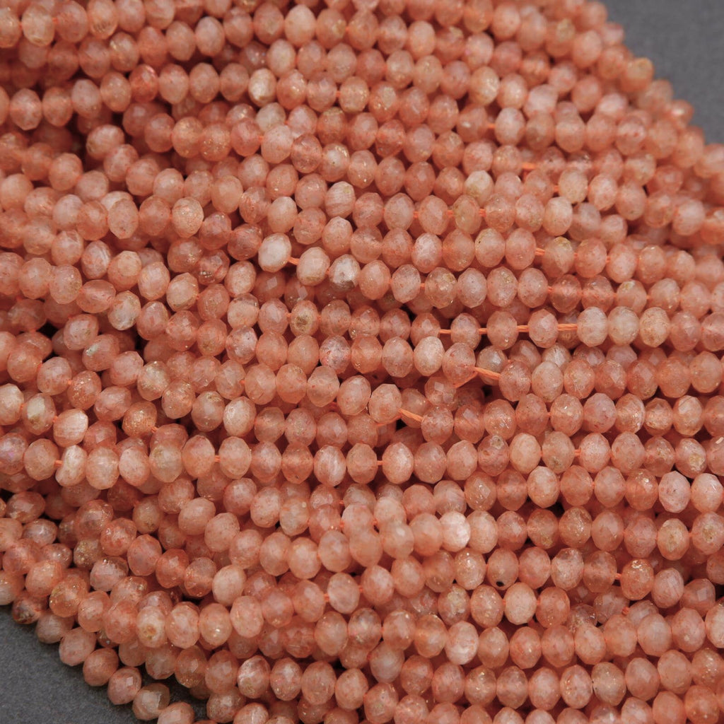 Close-up of pinkish-beige spherical beads on a gray background