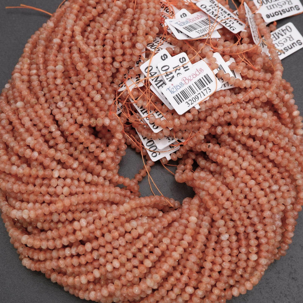 Pile of pink beads with price tags on a gray background