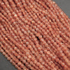 Close-up of a string of pink beads on a gray background