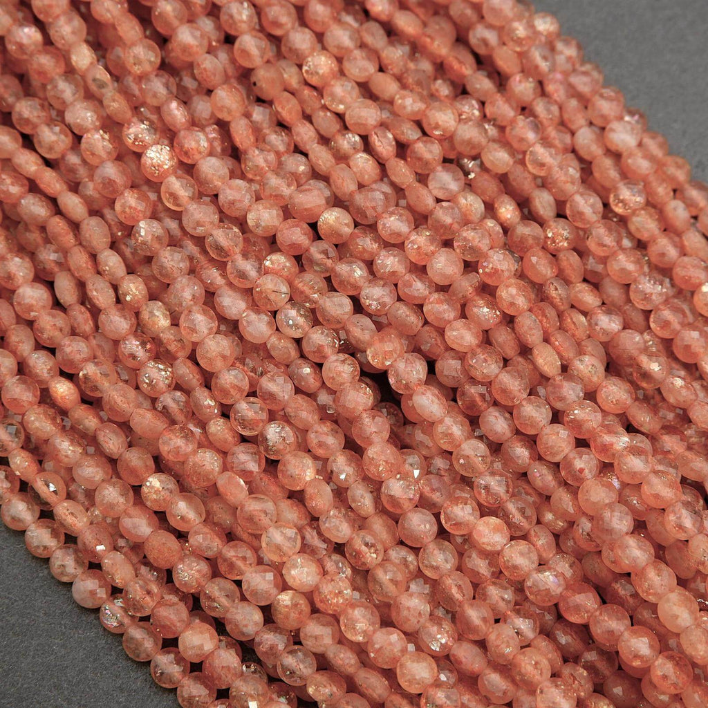 Close-up of a string of pink beads on a gray background