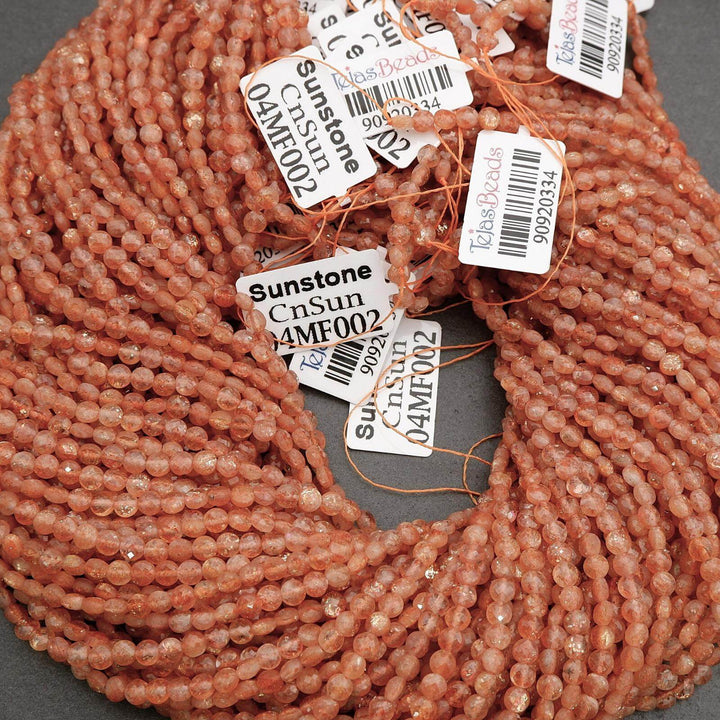 Close-up of pink beads with barcodes and labels on a gray background