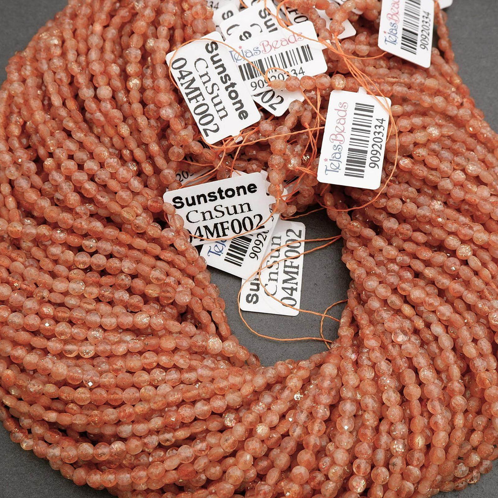 Close-up of pink beads with barcodes and labels on a gray background