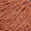 Close-up of pinkish-orange beads