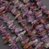 Close-up of purple and brown crystal beads on a dark surface
